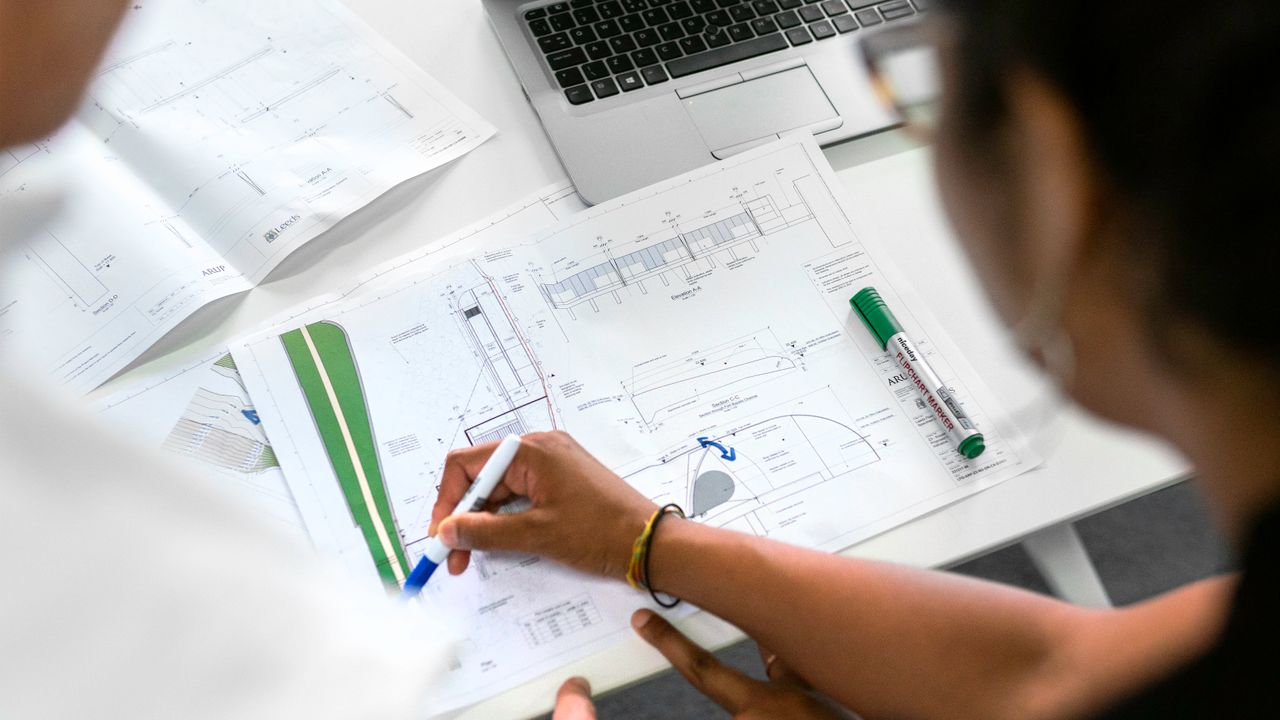California contractor reviewing blueprints at a home renovation site